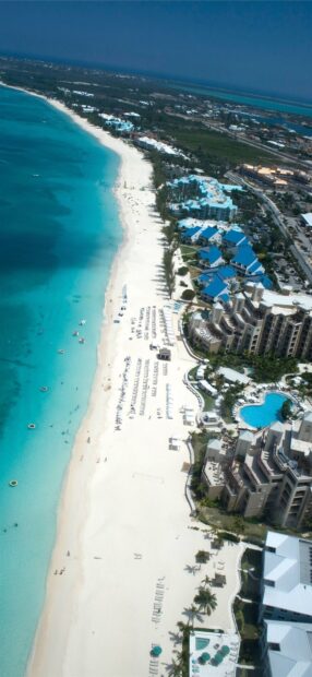 Aerial view of Cayman Islands coastline with white sandy beach and turquoise water