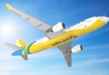 Colorful Cebu Pacific airplane flying in clear blue sky with sun flare, bright yellow, blue, and green livery, showcasing airline branding and jet engines.