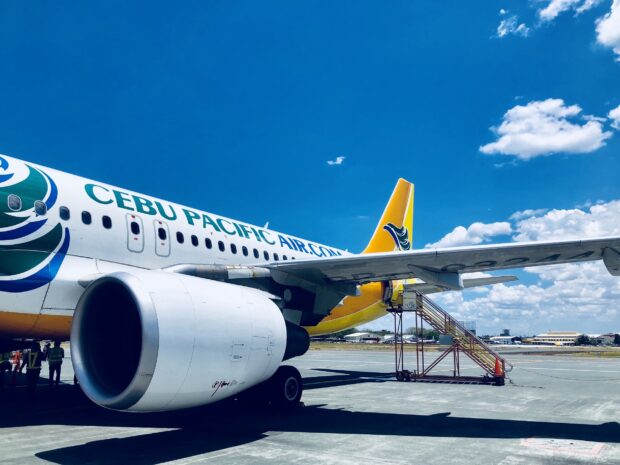 A Cebu Pacific Air airplane is parked on the runway under a blue sky, HD Desktop Wallpaper