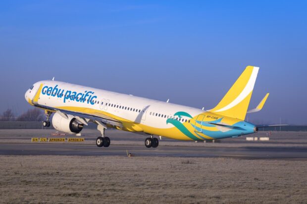 A Cebu Pacific Air airplane is taking off from the airport runway under clear blue sky, HD Desktop Wallpaper
