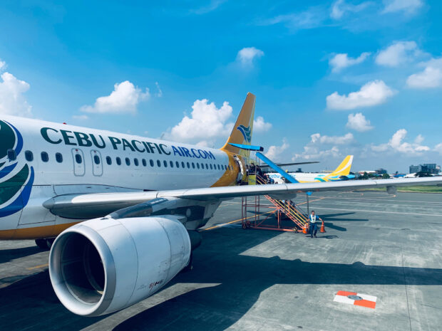 A Cebu Pacific Air airplane is parked on the runway under a clear sky, HD Desktop Wallpaper