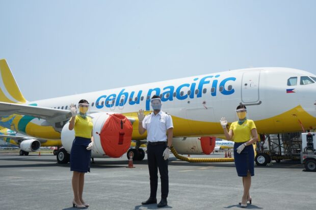 The Cebu Pacific Air crew members wave in front of the aircraft on a clear day, HD Desktop Wallpaper