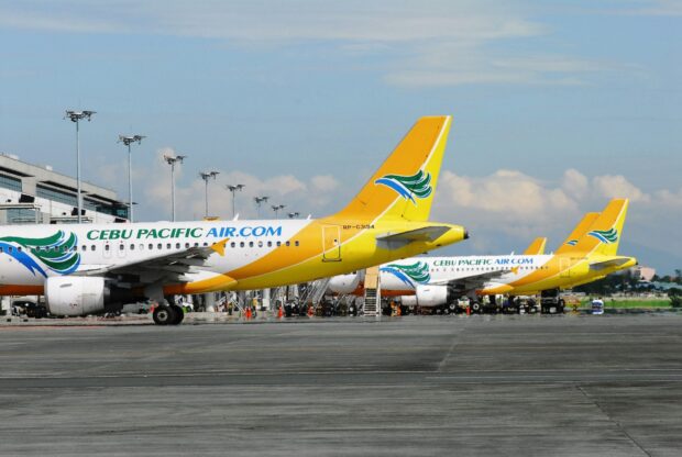 The Cebu Pacific Air planes are parked near the terminal under a clear sky, HD Desktop Wallpaper