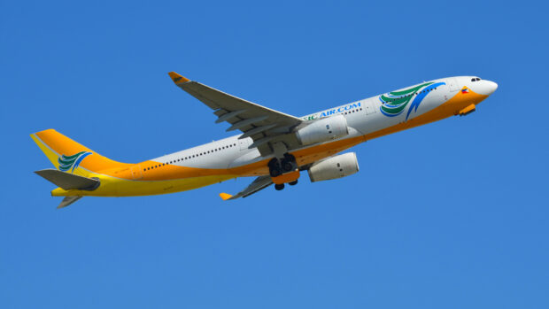A Cebu Pacific Air airplane is flying in a bright blue sky, HD Desktop Wallpaper