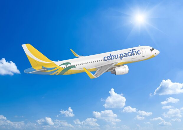 A Cebu Pacific Air jet flies high above the clouds on a sunny day, HD Desktop Wallpaper