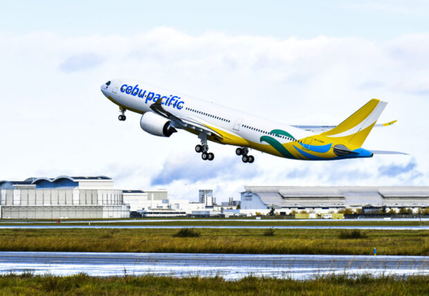 A Cebu Pacific Air airplane is taking off from the runway on a cloudy day, HD Desktop Wallpaper