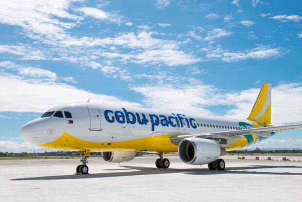 A Cebu Pacific Air passenger plane is parked on the airport runway under a blue sky with clouds, HD Desktop Wallpaper