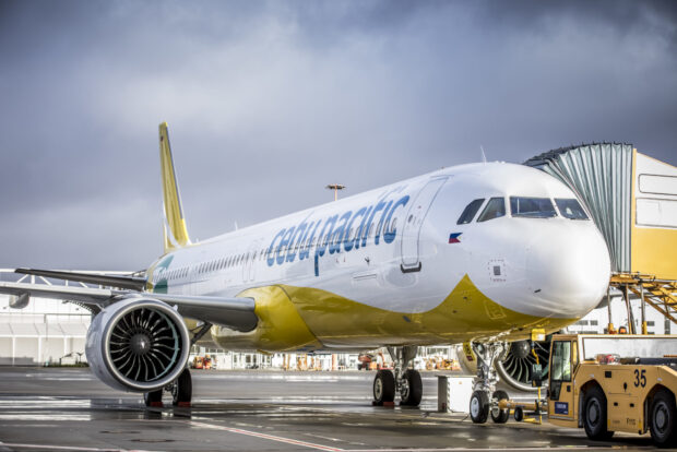A Cebu Pacific Air plane is parked at the gate on a cloudy day, HD Desktop Wallpaper