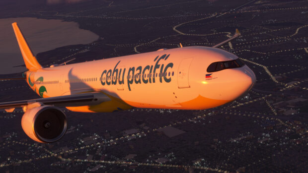 A Cebu Pacific Air plane is flying over a city during sunset, HD Desktop Wallpaper