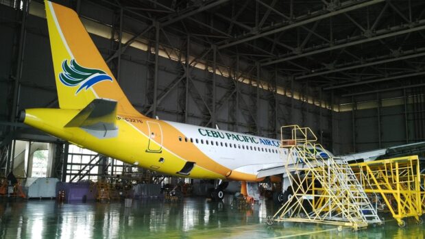A Cebu Pacific Air aircraft is parked inside a hangar for maintenance and inspection, HD Desktop Wallpaper