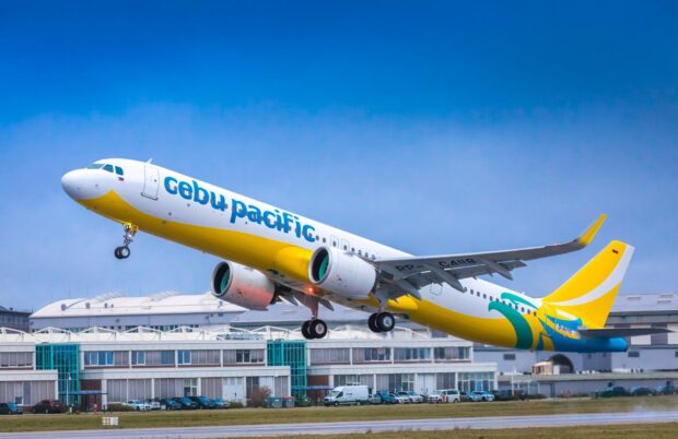 A Cebu Pacific Air plane is taking off from an airport runway under a clear blue sky, HD Desktop Wallpaper