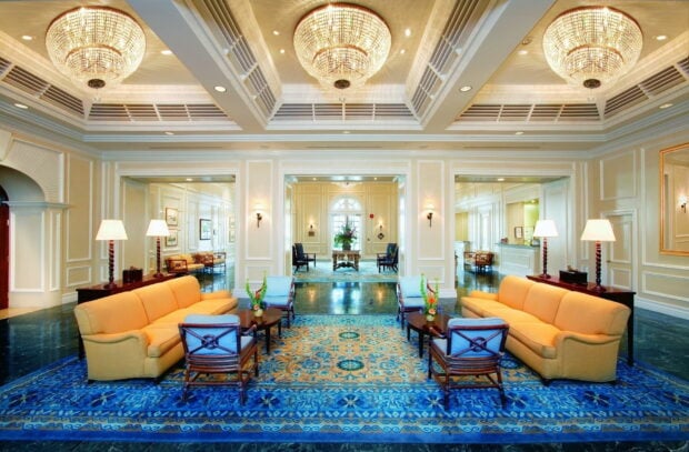 Elegant chandelier illuminating a luxurious living room with classic furniture and decor