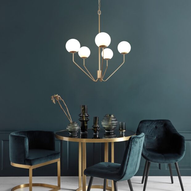 Modern chandelier design with round bulbs hanging over a stylish dining table setting