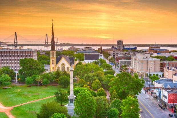 Historic Charleston South Carolina cityscape with church steeples and a bridge at sunset
