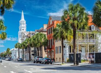 Historic Charleston South Carolina street lined with palm trees and colorful buildings