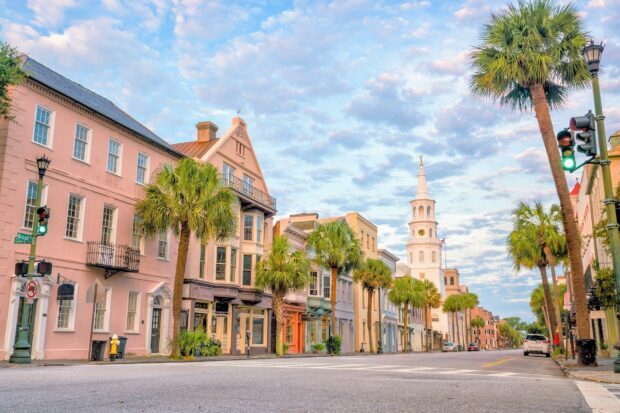 Charleston South Carolina street view with historic buildings and palm trees under a cloudy sky