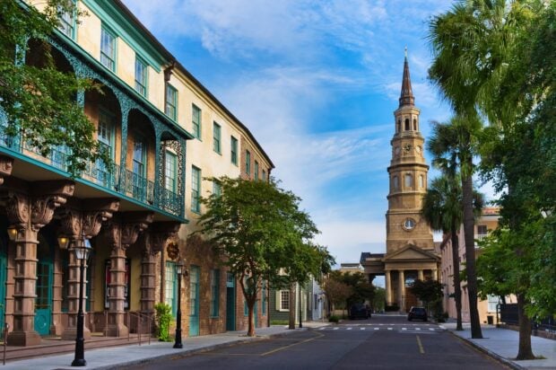 Historic Charleston South Carolina street with St. Philip's Church tower and colorful buildings