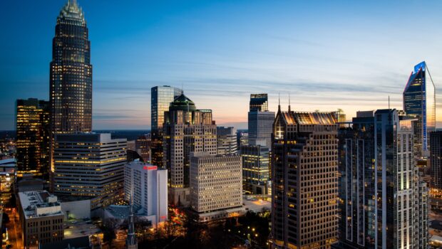 The Charlotte North Carolina skyline shows illuminated buildings at dusk, 2K Desktop Wallpaper
