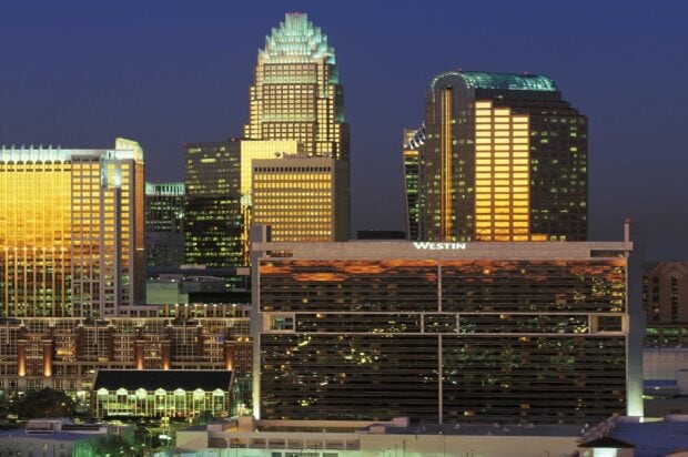 The Charlotte North Carolina skyline shines brightly with illuminated buildings during the night, HD Desktop Wallpaper