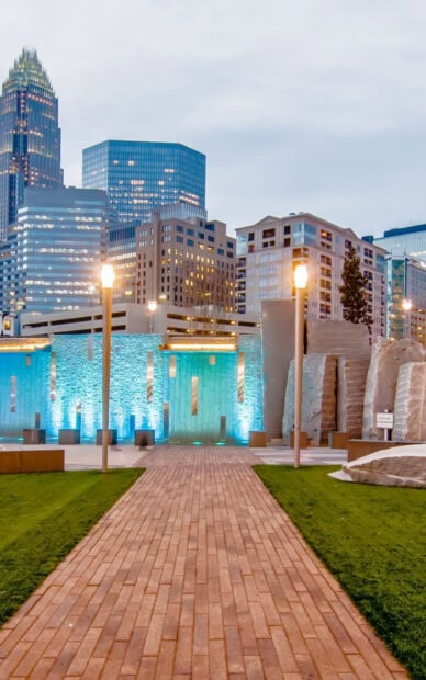 A scenic view of Charlotte North Carolina with illuminated buildings and a brick pathway, HD Phone Wallpaper
