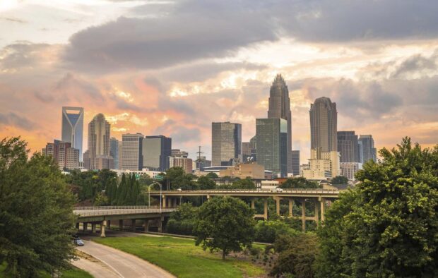 The Charlotte North Carolina skyline is visible with colorful clouds during sunset, HD Desktop Wallpaper