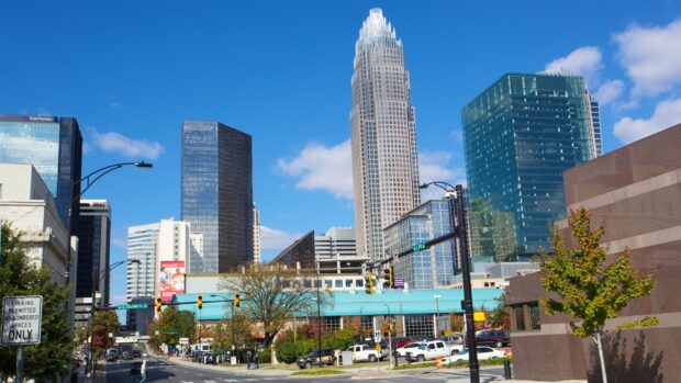 The Charlotte North Carolina skyline features tall modern buildings under a clear blue sky, 2K Desktop Wallpaper