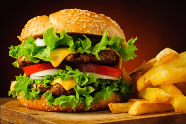 A cheeseburger with melted cheese, lettuce, tomato, and onions served with crispy French fries, 2K Desktop Wallpaper
