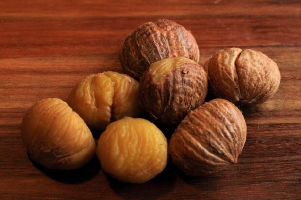 A close up view of chestnuts showing details of the shells and peeled nuts, HD Desktop Wallpaper