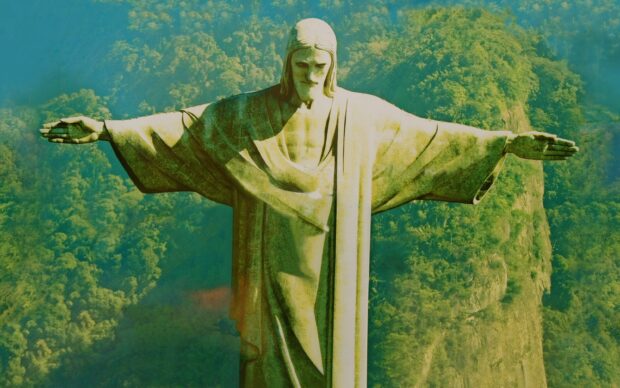 The Christ The Redeemer statue stands tall overlooking lush greenery in Brazil, 2K Desktop Wallpaper