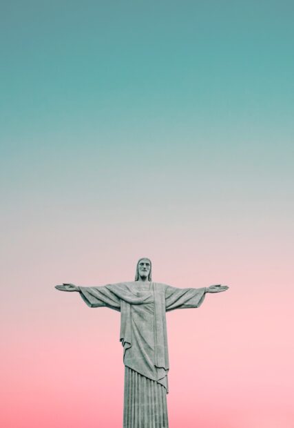 The Christ The Redeemer statue stands tall under a gradient sunset sky, 2K Mobile Wallpaper