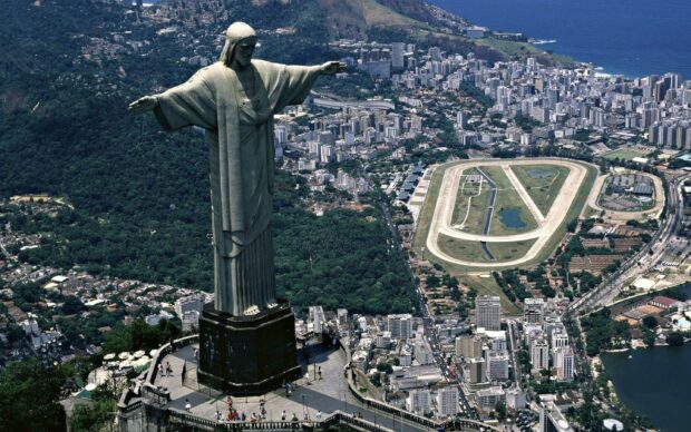 The Christ The Redeemer statue stands tall above the city of Rio de Janeiro with a breathtaking view, 2K Desktop Wallpaper