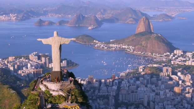 The Christ The Redeemer statue stands tall on the mountain overlooking the city and bay of Rio de Janeiro, HD Desktop Wallpaper