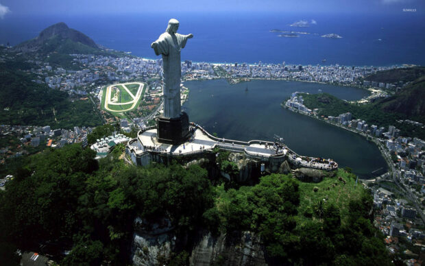 The Christ The Redeemer statue overlooks the city and bay in Brazil from a lush mountain viewpoint, HD Desktop Wallpaper