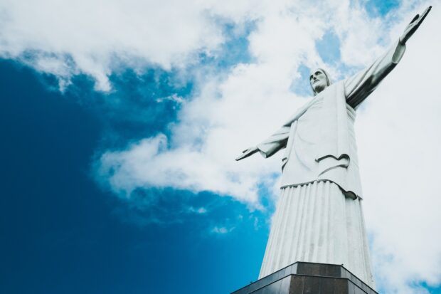 The Christ The Redeemer statue stands tall against a partly cloudy blue sky, HD Desktop Wallpaper