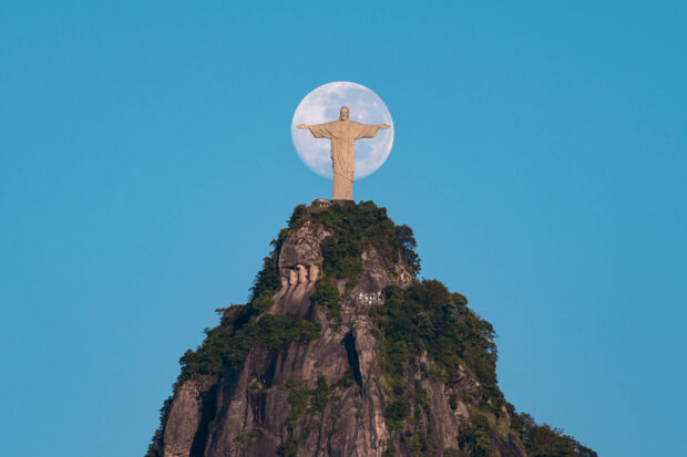 Christ The Redeemer stands tall with a full moon behind the statue over the mountain, HD Desktop Wallpaper