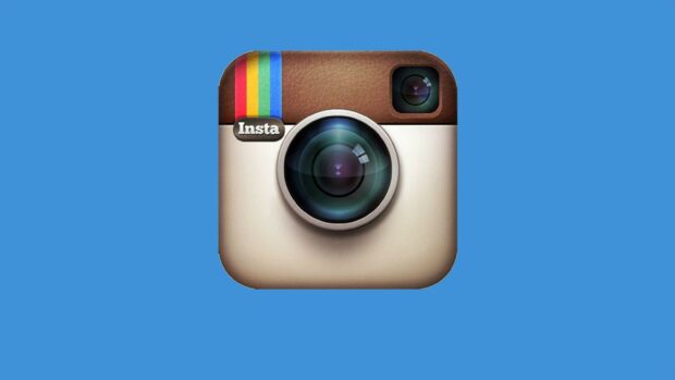 The image shows the classic Instagram icon with a camera lens on a blue backdrop featuring Instagram Wallpapers