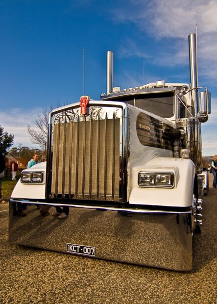 A classic Kenworth truck is parked outdoors under a bright blue sky, HD Mobile Wallpaper