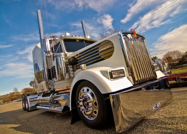 A gleaming Kenworth truck parked on a street under a bright blue sky, HD Desktop Wallpaper