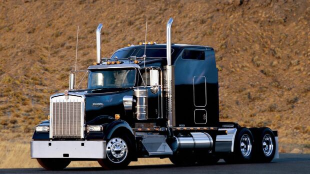 A Kenworth truck stands against a dry mountain backdrop, HD Desktop Wallpaper