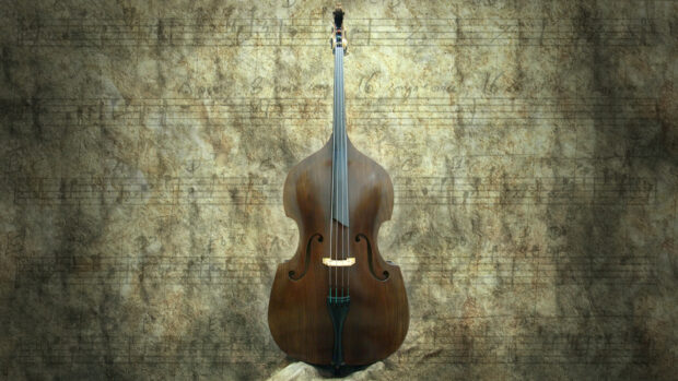A double bass resting against a textured vintage music sheet background, HD Desktop Wallpaper