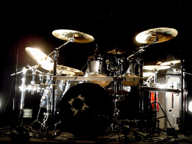 A classic drum set is displayed on stage with shining cymbals and drums, 2K PC Wallpaper