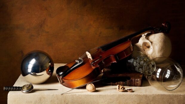 A classic violin resting beside a skull and decorative objects on a textured surface, HD Desktop Wallpaper