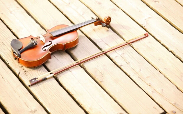 A violin lay on wood planks under soft sunlight, 2K Desktop Wallpaper