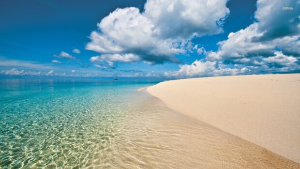 The Zanzibar Wallpapers show a calm beach with crystal clear water and cloudy sky, HD Desktop Wallpaper