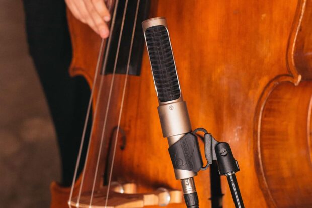 A close up of a double bass with a microphone attached during a recording session, HD Desktop Wallpaper