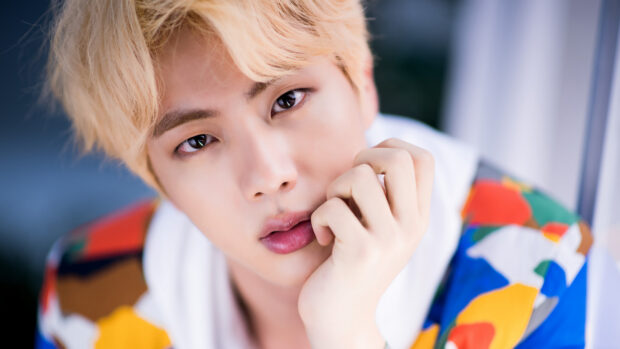 A close up of Jin BTS with blonde hair and colorful outfit looking at the camera, 4K Desktop Wallpaper