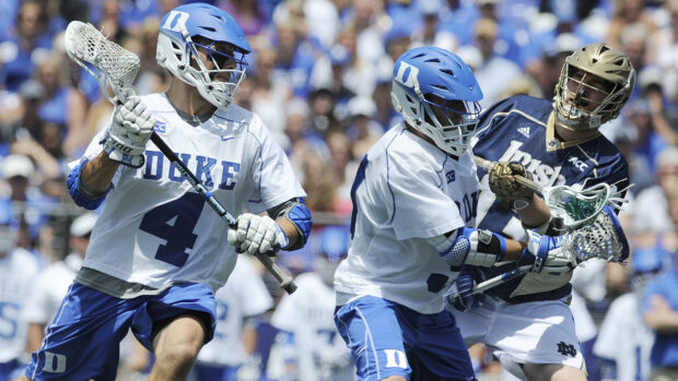 Two college lacrosse players in blue helmets and white jerseys compete against an opponent in a dark jersey, HD Desktop Wallpaper