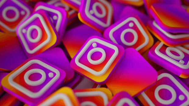 The image shows multiple colorful Instagram symbols stacked together in a pile, Instagram Wallpapers