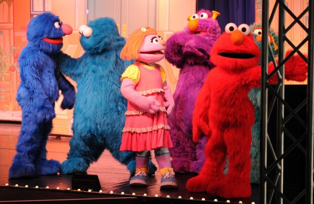 The Sesame Street characters are standing together on stage during a show, HD Desktop Wallpaper