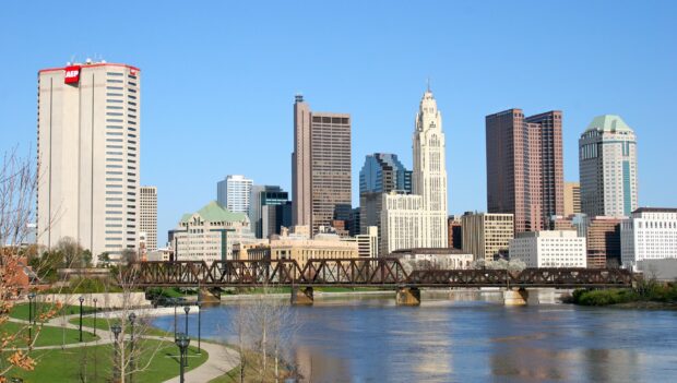 The Columbus Ohio skyline with river and bridge on a clear sunny day